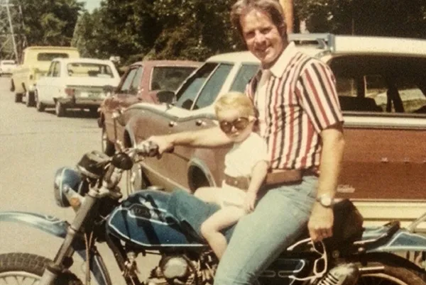 father and child on a motorcycle