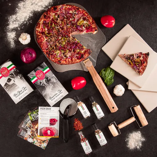 Showcasing ingredients and tools for grilling pizza, including recipe cards and spices. Items are scattered as if preparing for a pizza party.